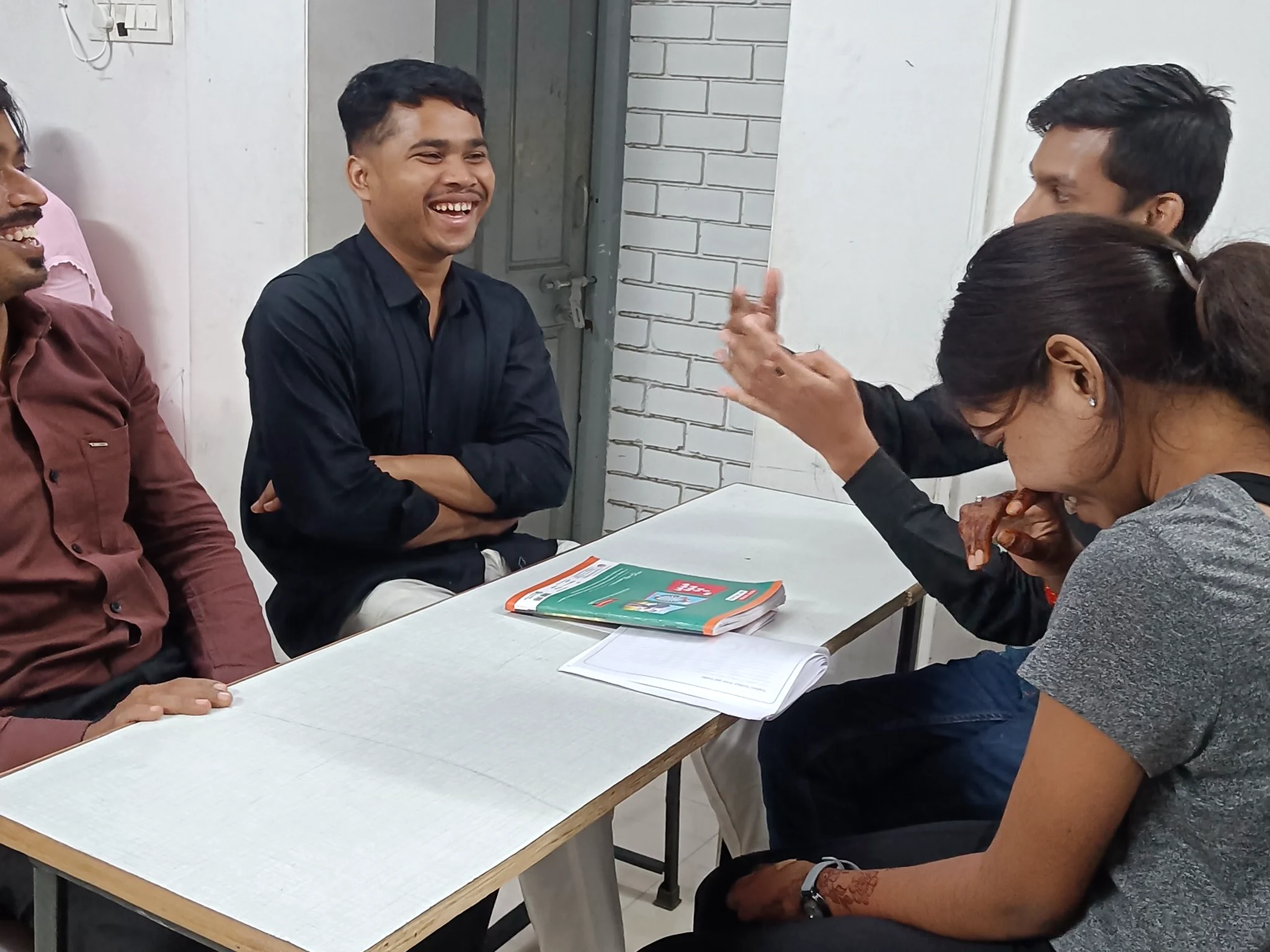 Students practising conversational English through group activities at AIM English Raipur