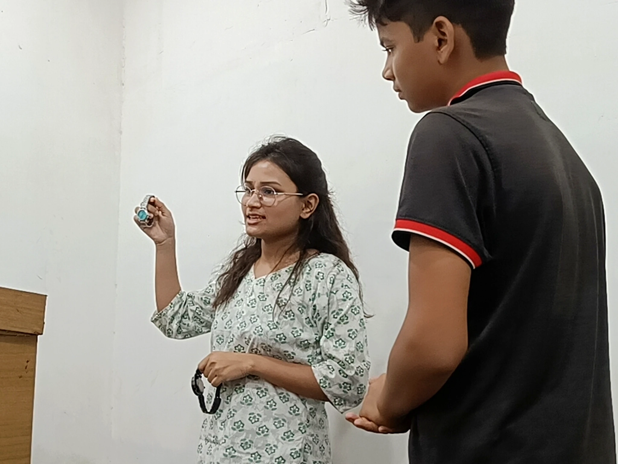 English teacher guiding students during a role play activity at AIM English Raipur