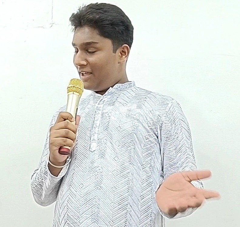 Student practising a real-life speaking situation with a microphone at AIM English Raipur