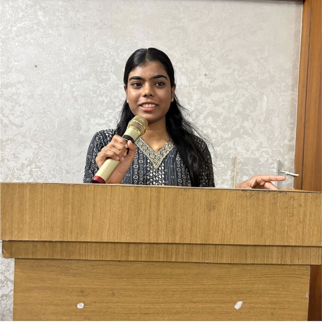 Student practising stage speaking and anchoring with a microphone at AIM English Raipur